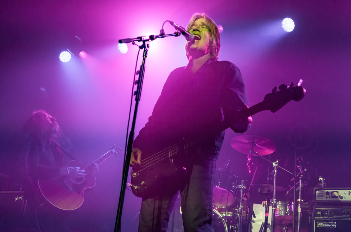 Photo of Justin Currie playing bass guitar and singing