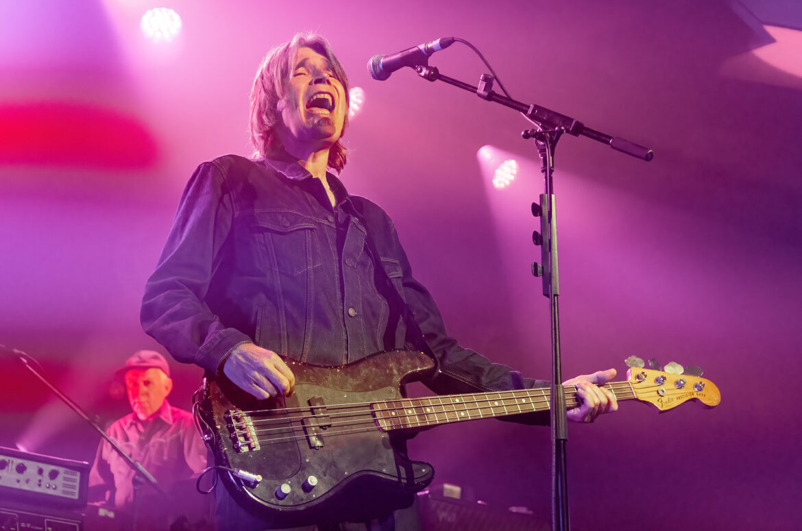 Photo of Justin Currie playing bass guitar and singing